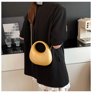 Chic yellow crescent acrylic clutch bag with round cut-out handle and gold chain strap
