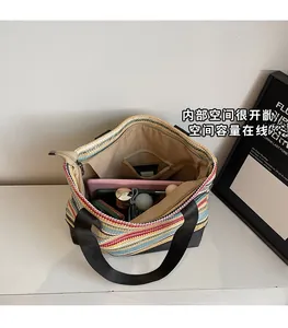 Spacious interior of a colorful woven tote bag showing internal pockets and large capacity