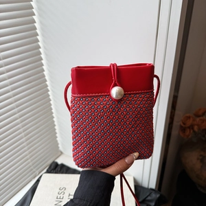 Mini straw woven crossbody bag in red and blue with a large pearl buckle decoration