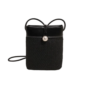 Mini black woven straw crossbody bag for women with pearl detail and slim shoulder strap