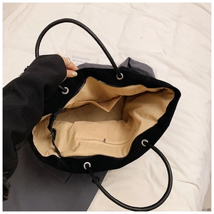 Detailed top view of the spacious black tote interior with lining and zip pocket