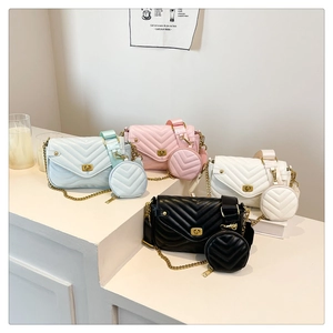 Detail of four quilted leather crossbody bags in pastel colors with mini round coin purses