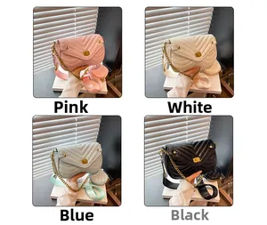 Close-up of quilted V-stitch crossbody bags with chain straps and wide shoulder straps