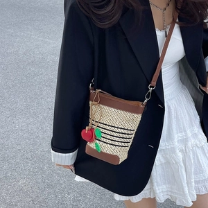 Mini straw bucket bag with contrast stripes, leather trim and cherry pendant accessory