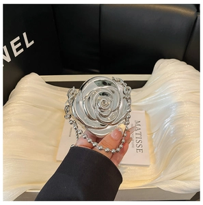 Détail d'une pochette rose en acrylique argenté avec chaîne à billes et effet miroir