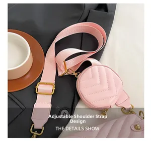 Adjustable wide nylon strap detail on pink quilted round shoulder bag with gold hardware