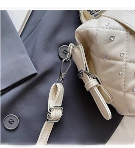 Detail of quilted leather bag with sparkling rhinestones and silver metal lobster clasp