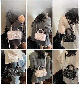 Detailed views of quilted Boston bag with studs in black and pink leather-like finish