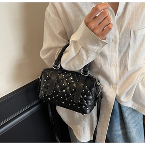 Detail of black quilted Boston bag with silver rhinestones and adjustable strap