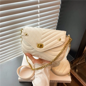 White chevron quilted leather crossbody bag with gold hardware and wide strap