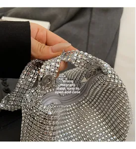 Detail of silver rhinestone evening bag featuring strong magnetic snap and zipper closure