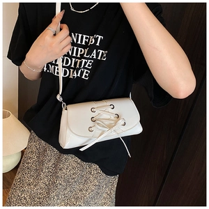 White faux leather crossbody bag with silver eyelets and trendy lace-up detail design