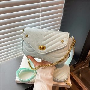 Chic mint green quilted crossbody bag with golden chain strap and mini pouch