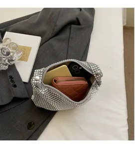 Detailed internal view showing storage capacity for wallet and phone in silver rhinestone bag