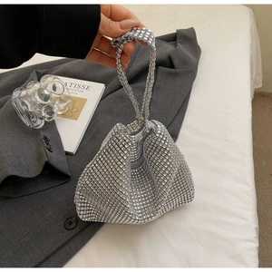 Detail of silver rhinestone evening handbag with sparkling crystal handle and soft texture