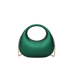 Dark green acrylic crescent evening clutch bag with gold chain strap on white background