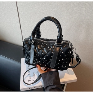Close-up of black quilted Boston bag with silver rhinestones and metal hardware details
