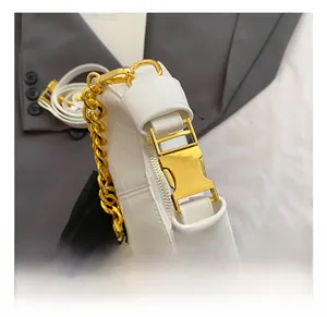 Detail of white patent leather bag with chunky gold chain and metallic buckle closure
