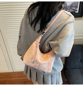Close-up of sparkling light pink rhinestone shoulder bag with adjustable silver buckle