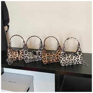 Detailed row of vintage leopard print hobo bags with glossy finish and silver chain decor