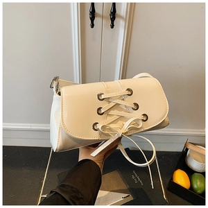 White glossy leather shoulder bag with chic eyelet lacing and bow ribbon detail