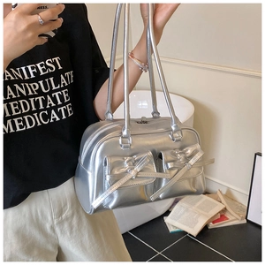 Close-up of silver metallic bowling bag featuring dual front pockets and leather bows