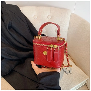 Red quilted leather mini handbag with a gold flower buckle and chain shoulder strap