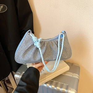 Light blue woven crescent shoulder bag with knotted handle and houndstooth pattern