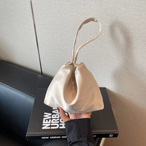 Elegant champagne satin triangular handbag with sleek top handle and natural glossy finish