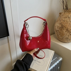 Sac croissant en cuir verni rouge avec pendentif boule argentée et bandoulière