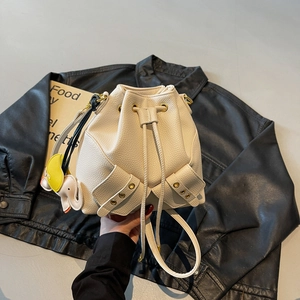 Creamy white drawstring bucket bag with litchi grain leather and elephant charm