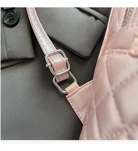 Detailed macro view of pink quilted texture with adjustable silver metallic buckle