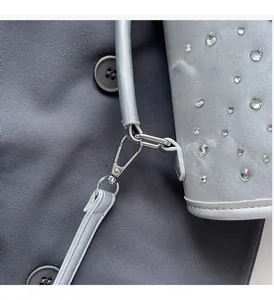 Detailed macro view of silver rhinestones and high-quality metal hardware on a backpack