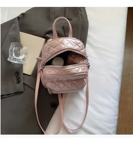 Pink quilted backpack with a view showing interior space for water bottle and umbrella