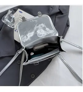 Internal view of silver metallic bag showing space for a smartphone and lipstick
