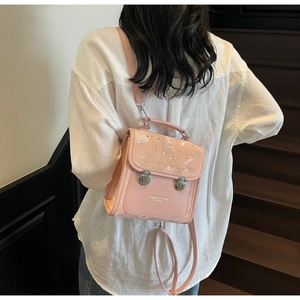 Detailed close-up of pink mini sequin backpack with sparkling rhinestones and silver clasps