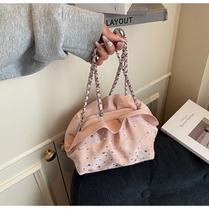 Close-up of pink ruched hobo bag with sparkling silver rhinestones and chain strap