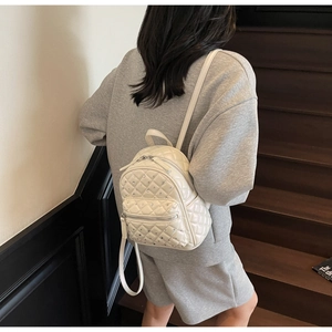 Quilted mini backpack in cream white featuring elegant diamond stitching and rhinestones