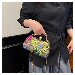Detail of colorful sequins and vintage gold handle on the evening clutch bag