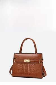 Detailed view of brown retro handbag with smooth leather and crocodile embossed texture