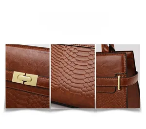 Macro view of dark brown faux crocodile leather texture and golden metal buckle detail