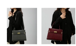 Detail of structured embossed leather handbag with gold twist lock and shoulder strap