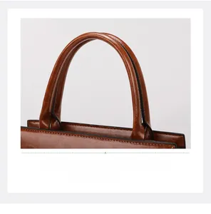 Detailed macro view of the brown leather handles and smooth black edge oil craftsmanship