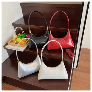 Selection of crescent shoulder bags in black, red, white, and silver with metal buckles