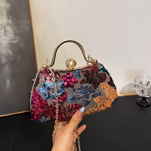 Vintage floral sequined clutch bag with metal handle and pearl clasp shown with chain