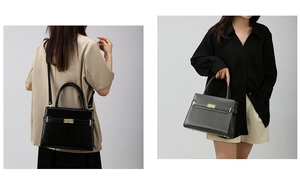 Detail of black embossed leather handbag featuring gold clasp and versatile carrying options