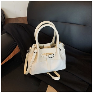 Détail du sac à main blanc crème avec textures lisses et tissées et fine bandoulière