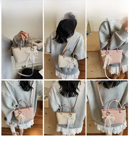 Detailed views of woven straw handbags with lace bows and pearl charms on a model