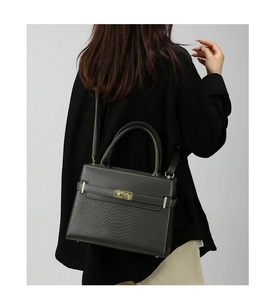 Deep grey tote bag with snakeskin pattern and gold hardware shown on a model