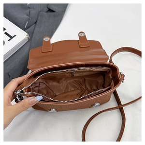 Interior view of brown messenger bag showing main compartment and zipper pocket